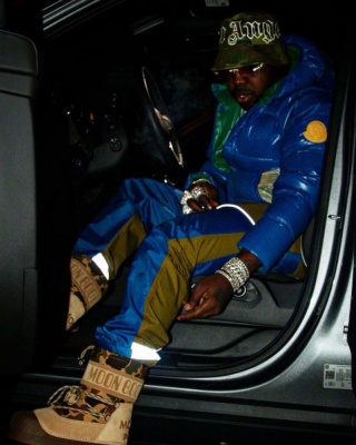 Est Gee Wearing A Palm Angels Bucket Hat With A Moncler Puffer Moncler Trackpants And Moncler Moon Boots