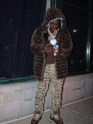 Est Gee Wearing A Supreme Fur Coat With A Dior Brown Oblique Tee Givenchy Jeans And Dior Sneakers