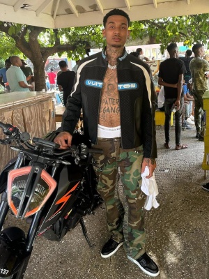 Fredo Wearing A Louis Vuitton Moto Racing Jacket With Gallery Dept Camo Cargos And Lv Sneakers