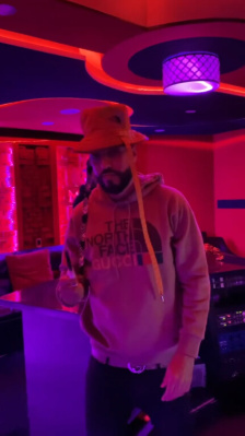 French Montana Wearing A Gucci X The North Face Black Bucket Hat And Brown Logo Hoodie
