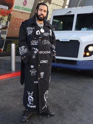 French Montana Wearing A Kidsuper Black Printed Overcoat With Louis Vuitton Skate Sneakers