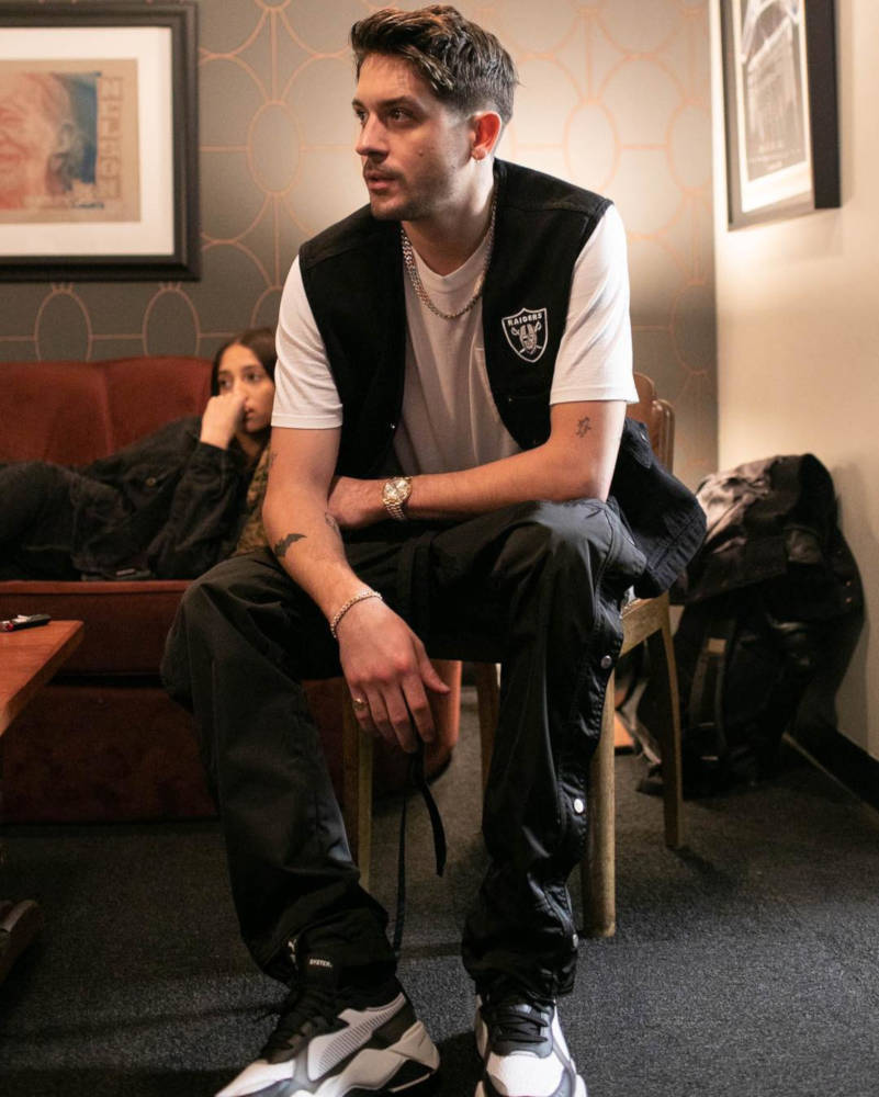 G-Eazy Wearing a Supreme Raiders Vest and Puma RS-X Tech Sneakers