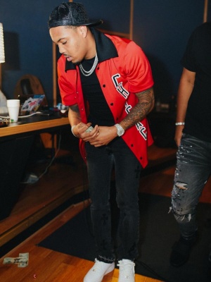G Herbo Weraring A Mitchell And Ness Chicago Bull Shirt With A Chrome Hearts Hat And Jeans