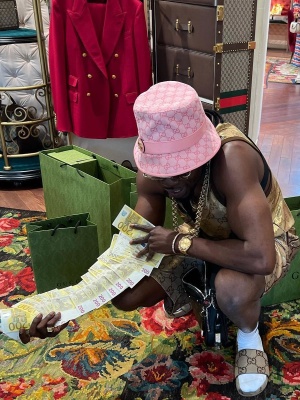 Gazo Wearing A Pink Gucci Bucket Hat With Matching Gold Tank Top And Short And Beige Gg Canvas Slides