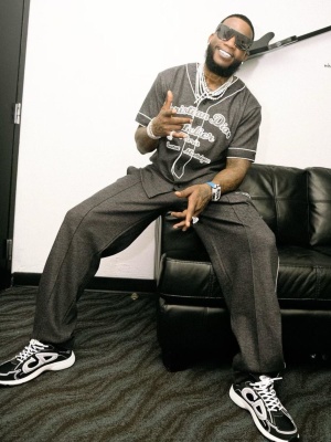 Gucci Mane Wearing Black Dior Sunglasses With A Dark Grey Dior Baseball Jersey And Trackpants And B30 Sneakers