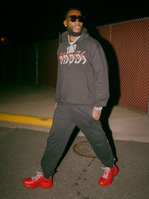 Gucci Mane Wearing Gucci Flat Top Sunglasses With A Black Mirror Logo Hoodie And Sweatpants And Red Sneakers