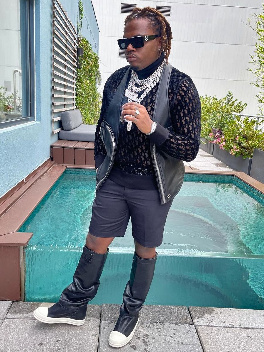 Gunna wearing Louis Vuitton Classic Black Sunglasses, A-Cold-Wall Black  Padded Jacket, Louis Vuitton Anagram Revers…