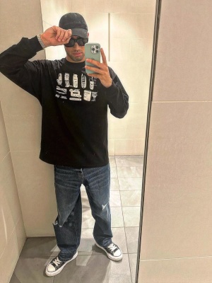 Hakimi Wearing An Black Long Sleeve Cellphone Print Tee Balenicaga Hat And Mmy Sneakers