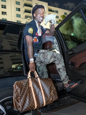 Hotboii Wearing A Louis Vuitton X Nba T Shirt With Louis Vuitton Luxemborgh Sneakers And A Louis Vuitton Brown Monogram Bag