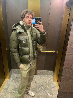Jack Harlow Wearing An Olive Green Moncler Puffer Jacket With A Bottega Veneta Tracksuit And New Balance Sneakers