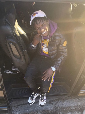 Jackboy Wearing A 47 Brand Lakers Hat With A Moncler Puffer Lakers Hoodie Amiri X Lakers Jeans And Dior Purple Sneakers