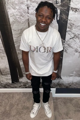 Jackboy Wearing A Dior Flower Tee With Black Amiri Jeans And Multicolor Oblique High Top Sneakers