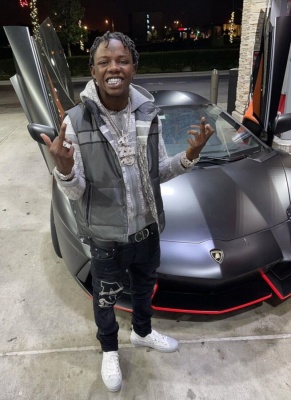 Jackboy Wearing A Dior Grey Oblique Vest Hoodie And Sneakers With A Dior Belt And Amiri Varsity Jeans