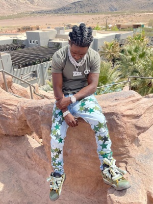Jackboy Wearing A Dior Olive Green And Ivory Cd Icon Tee With Amiri X Chemist Light Indigo And Green Star Jeans And Lanvin Green Curb Sneakers