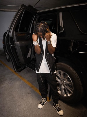 Jackboy Wearing A Rick Owens Cargo Vest With A White Long T Shirt Black Cargo Pants And Hexa Lace Sneakers