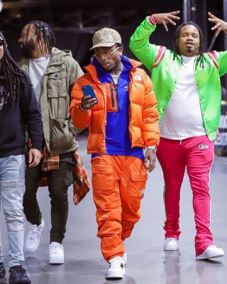 Jacquees Wearing A Gucci X Tnf Beige Gg Hat Blue Zip Jacket And Ornage Pants With A Tnf Jacket And Gucci Sneakers