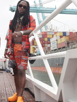 Jacquees Weraing Palm Angels Sunglasses With A Red Hawaiian Shirt And Swim Shorts With Bottega Veneta Clogs