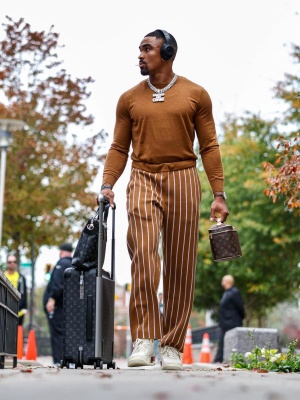 Jalen Hurts Wearing A Brown Sweater With Brown Striped Pants Lv Bags And Jordan Sneakers
