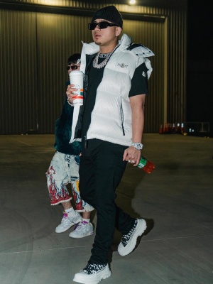 Jesus Ortiz Paz Wearing A Moncler Logo Beanie And Tee With A White Puffer Vest And Mcqueen Graffiti Sneakers