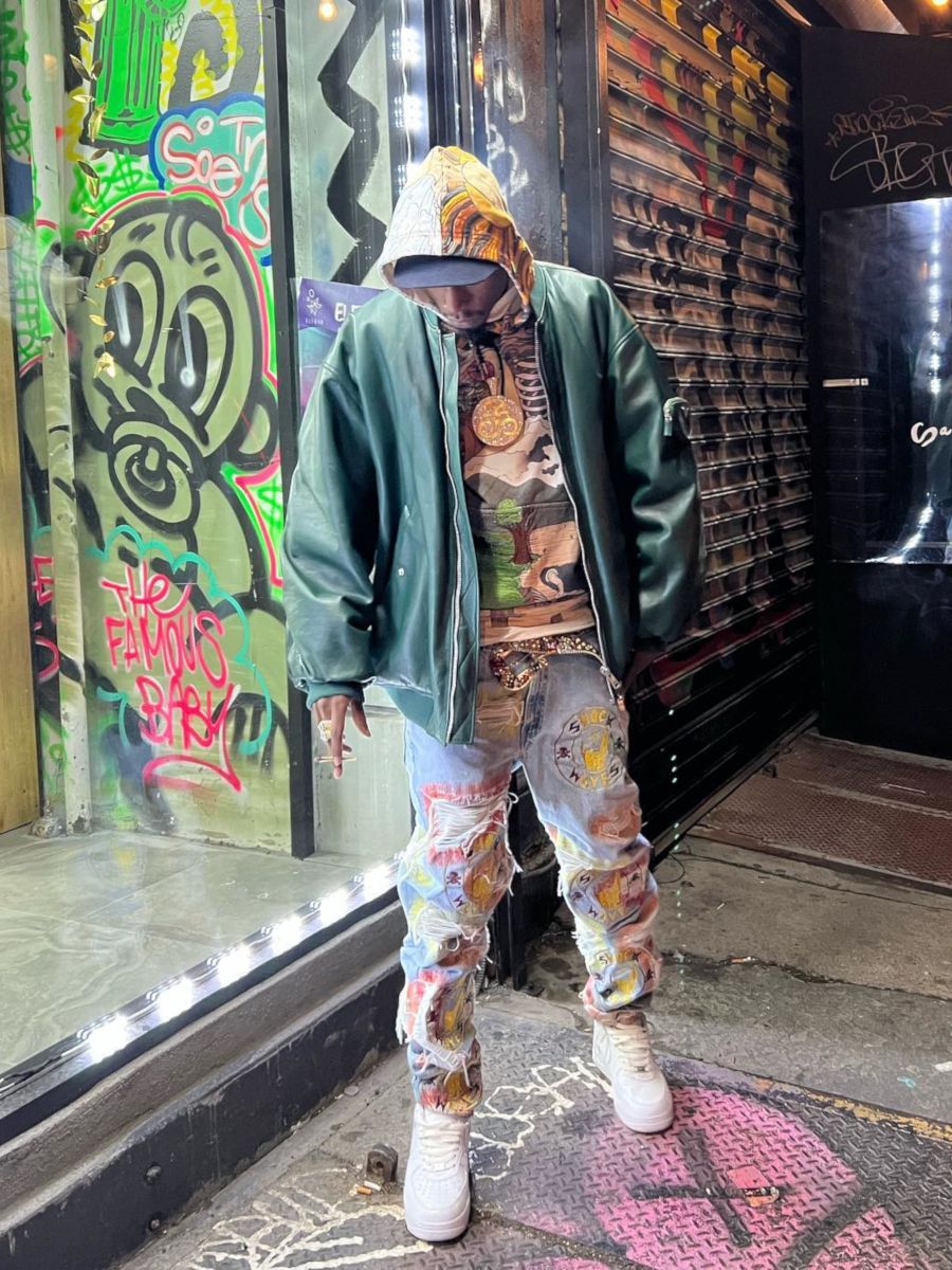 Joey Badass Wearing a Green Bomber Jacket With a WDW Hoodie & 1 of 1 Jeans