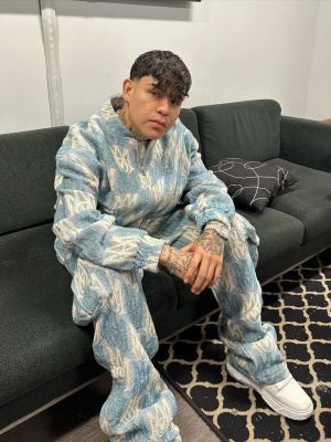 Junion H Wearing An Amiri Tapestry Jacket And Pants With Low Top Sneakers