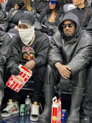 Kanye West Wearing Balenciaga Sunglasses With A Black Leather Jacket And Balenciaga X Crocs Boots
