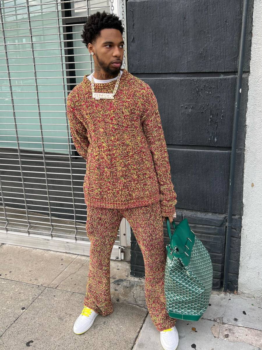 Key Glock Wearing a Speckled Marni Sweater & Pants With a Goyard Backpack