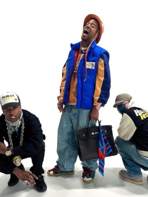 Kid Cudi Wearing A Gucci X Tnf Bucket Hat And Blue Puffer Vest With A Hermes Birkin Bag And Lanvin Sneakers