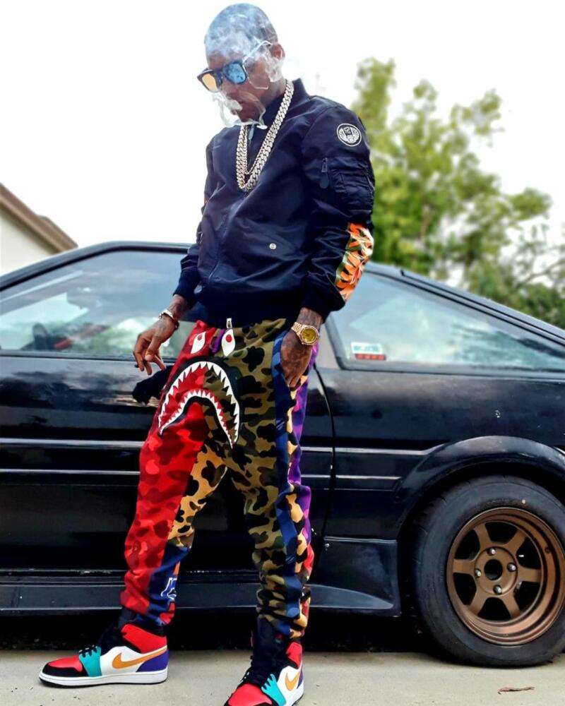 Kid Ink Wearing a BAPE Bomber and Joggers, with Multicolor Bred Jordan 1's