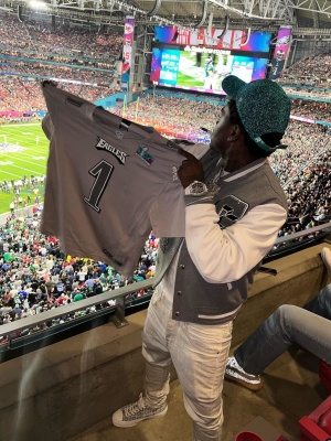 Kodak Black Watches Superbowl Lvii In A Givenchy Jacket And Sneakers Purple Brand Jeans And A 47 Brand Hat