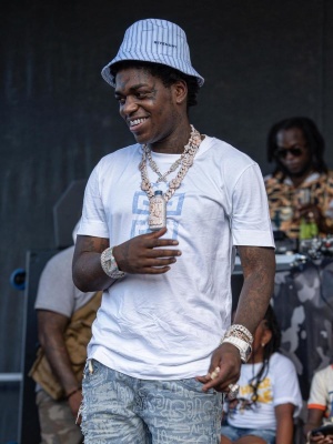 Kodak Wearing A Givenchy Striped Bucket Hat With A White Tee And Graffiti Jeans
