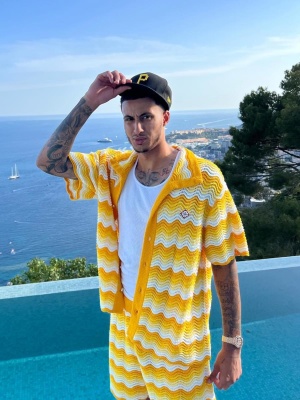 Kyle Kuzma Wearing A Pirated Hat With A Casablanca Yellow Crochet Shirt And Shorts