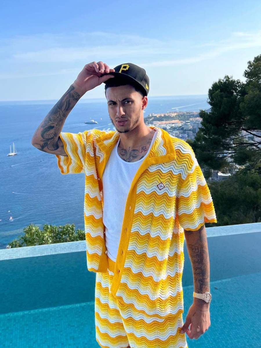 Kyle Kuzma Wearing a Wavy Yellow Knit Shirt & Shorts With a Pirates Fitted