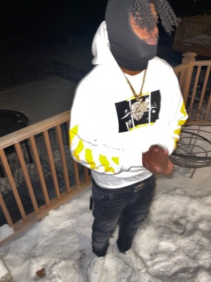 Lamar Jackson Wearing An Off White White And Yellow Hoodie With An Amiri Belt Black Jeans And Off White Sneakers