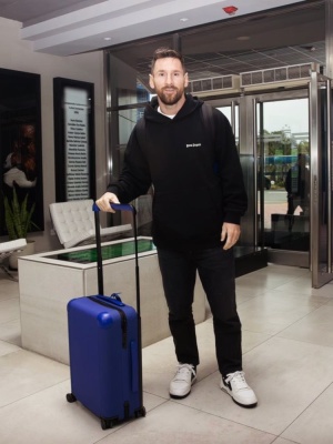 Leo Messi Wearing A Palm Angels Black Hoodie Hoodie Off White Sneakers And Louis Vuitton Blue Suitcase