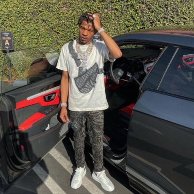 Lil Baby In A Dior Saddle Bag Print T Shirt With Amiri Snakeskin Print Jeans And Alexander Mcqueen Sneakers