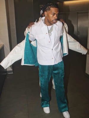 Lil Baby Wearing A Bottega Veneta Glossy White Jacket With A White Shirt And Teal Corduroy Cargo Pants