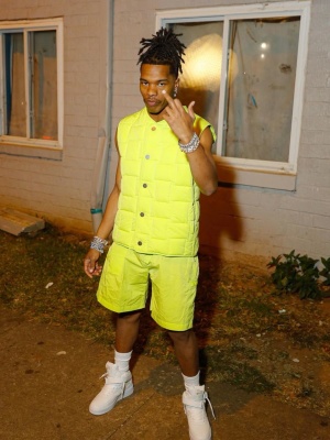 Lil Baby Wearing A Bottega Veneta Yellow Vest With Matching Cargo Shorts And Nike X Louis Vuitton High Top Sneakers
