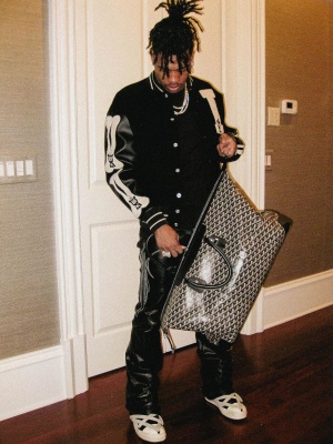 Lil Baby Wearing A Kapital Black Leather Jacket With Leather Pants And Rick Owens Sneakers With A Goyard Duffle Bag