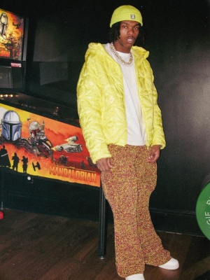 Lil Baby Wearing A Louis Vuitton Yellow Beanie And Lvse Quilted Jacket With Marni Pants And Nike Air Force 1 Sneakers