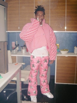Lil Baby Wearing A Sp5der Worldwide Pink Five Star Puffer Jacket With Erl Pants And Nike X Cpfm Sneakers