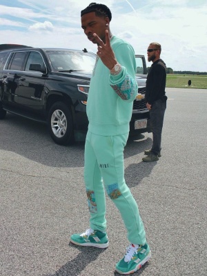 Lil Baby Wearing An Amiri Light Green Quilt Patch Sweatshirt And Sweatpants With Nike Sneakers
