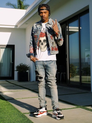 Lil Baby Wearing An Amiri X Grateful Dead Denim Jacket And Tee With Varsity Jeans And Dior Sneakers
