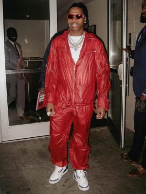Lil Bay Wearing Red Sunglasses With A Ferragamo Jacket And Pants And Jordan 3s