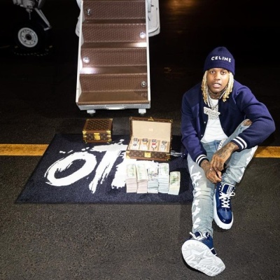 Lil Durk Wearing A Celine Navy Logo Beanie With A Navy Varsity Jacket Amiri Bones Jeans And Dior Sneakers