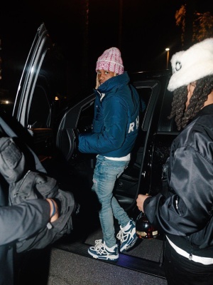 Lil Durk Wearing A Chanel Beanie With A Rhude Puffer Jacket Amiri Indigo And Pink Jeans And Louis Vuitton Skate Sneakers