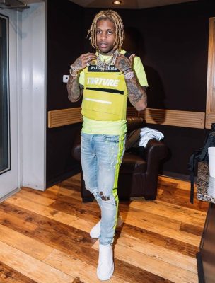 Lil Durk Wearing Yellow Tactical Vest And Amiri Jeans With Yellow Side Stripe