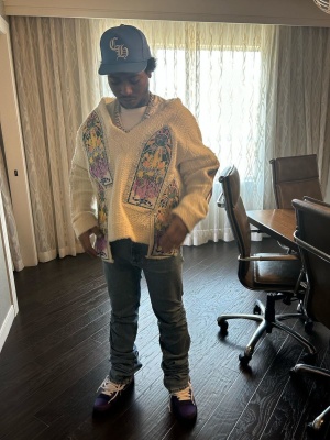Lil Meech Wearing A Chrome Hearts Hat With A Who Decides War Sweater And Nike Lobster Dunks