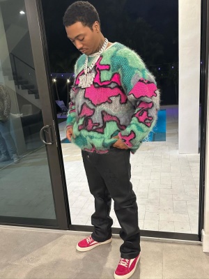 Lil Meech Wearing A Loewe Sweater With Chrome Hearts Jeans And Rick Owens Fuchsia Suede Sneakers