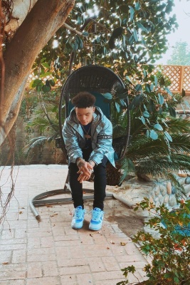 Lil Mosey Wearing A Dior Silver Hooded Windbreaker Jacket With Black Jeans And Nike Air Force 1 Sneakers